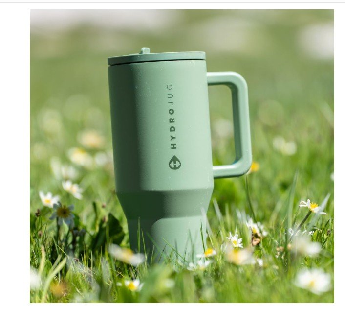 Sage green HydroJug tumbler in a field of wildflowers.