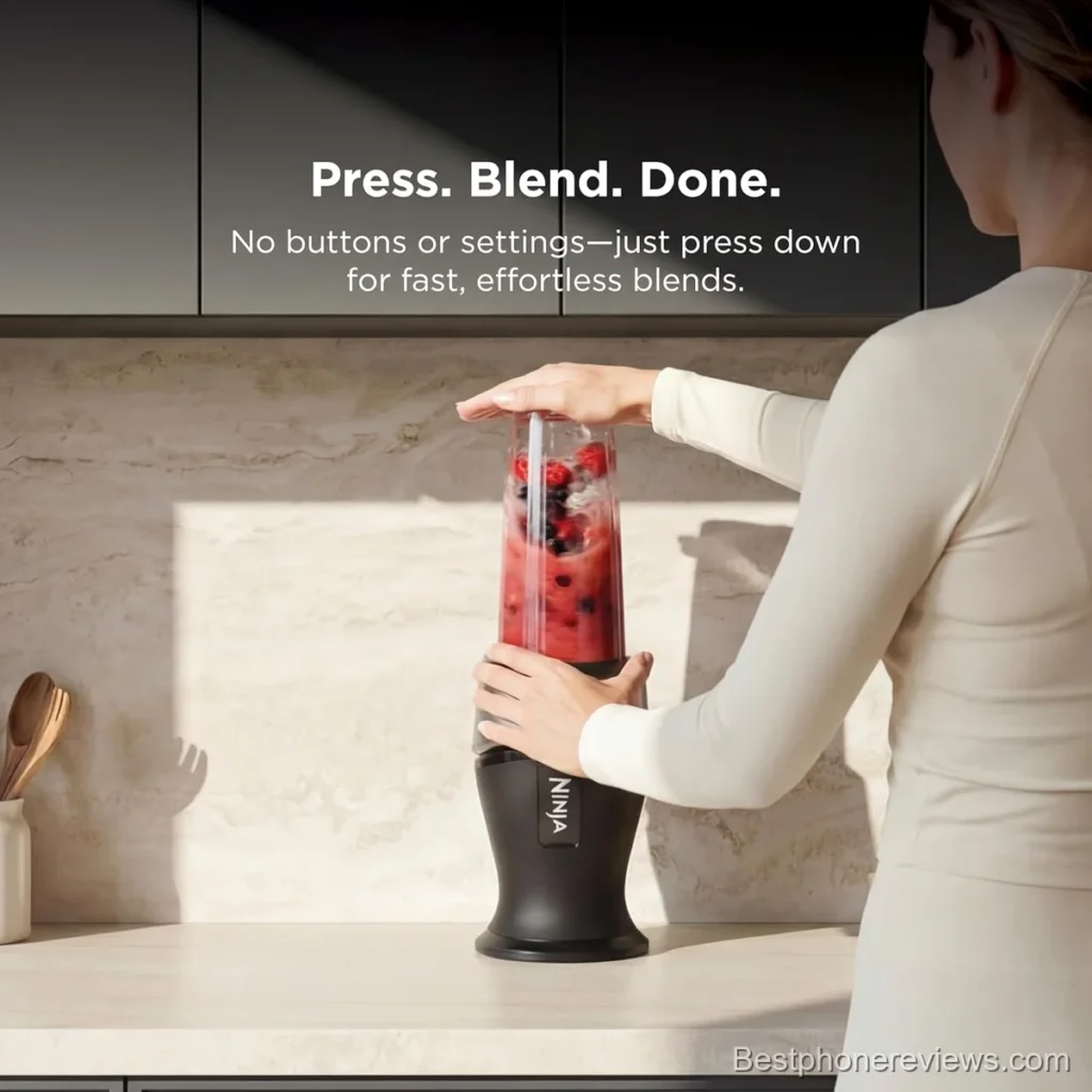 Woman using a Ninja blender to make a berry smoothie.